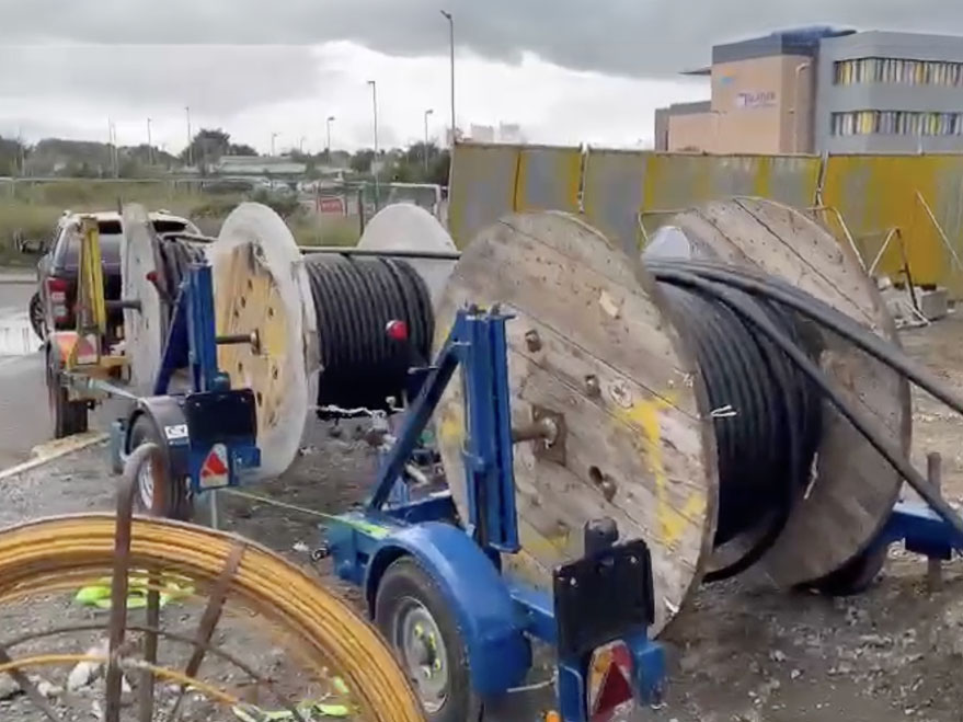 Three cable drums towed by pickup truck